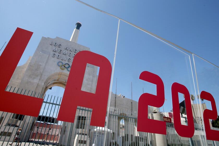 LOS ANGELES, CALIF. - SEP. 13, 2017. The Los Angeles Memorial Coliseum is framed by a plexiglass sign after the city was officially awarded the rights to host the 2028 Olympic Games on Wednesday, Sep. 13, 2017. (Luis Sinco/Los Angeles Times)