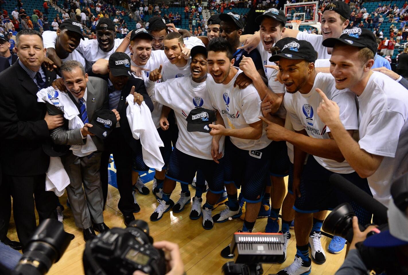 UCLA players celebrate their 75-71 upset win over Arizona in the Pac-12 tournament title game at the MGM Garden Arena in Las Vegas on Saturday.