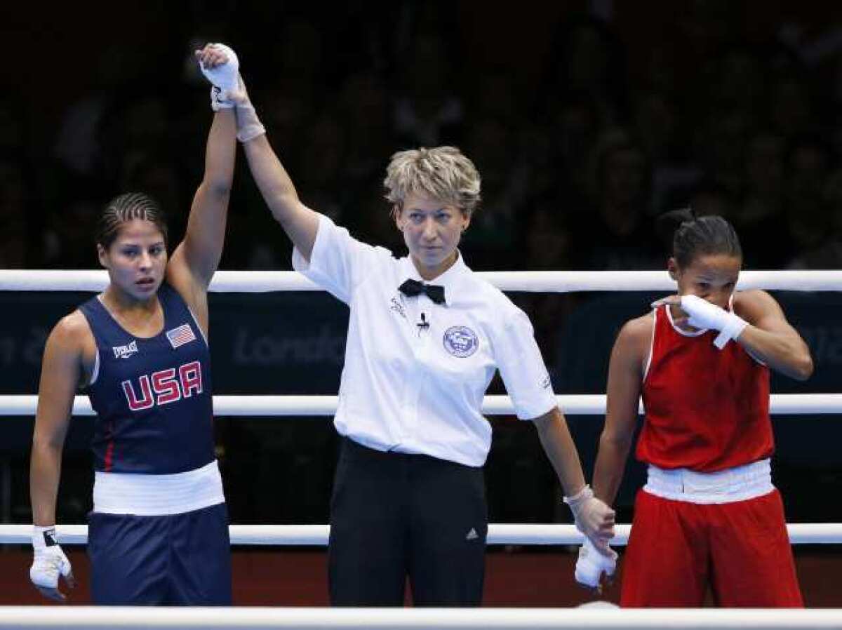 Marlen Esparza has her hand raised in victory after defeating Karlha Magliocco of Venezuela.