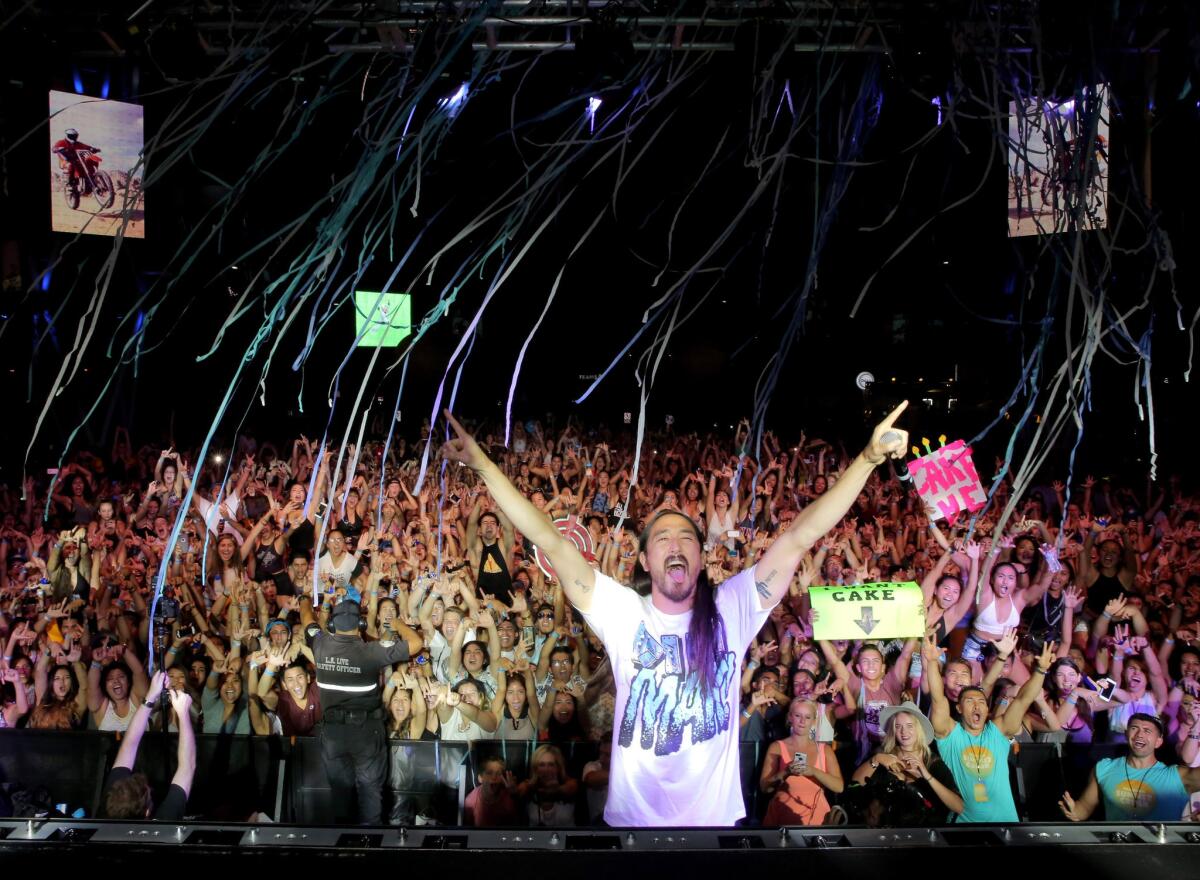 DJ Steve Aoki is throwing a massive, $1,000-a-head pizza party in Beverly Hills for charity. Pictured is Aoki performing at the Pandora Summer Crush in Los Angeles earlier this year.