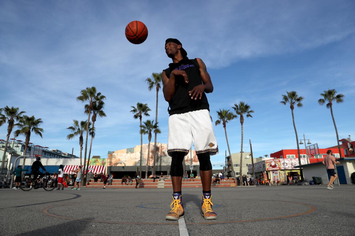 Basketball player Chris Staples wears Kobe Bryant shoes on the public courts on Friday in Venice Beach.