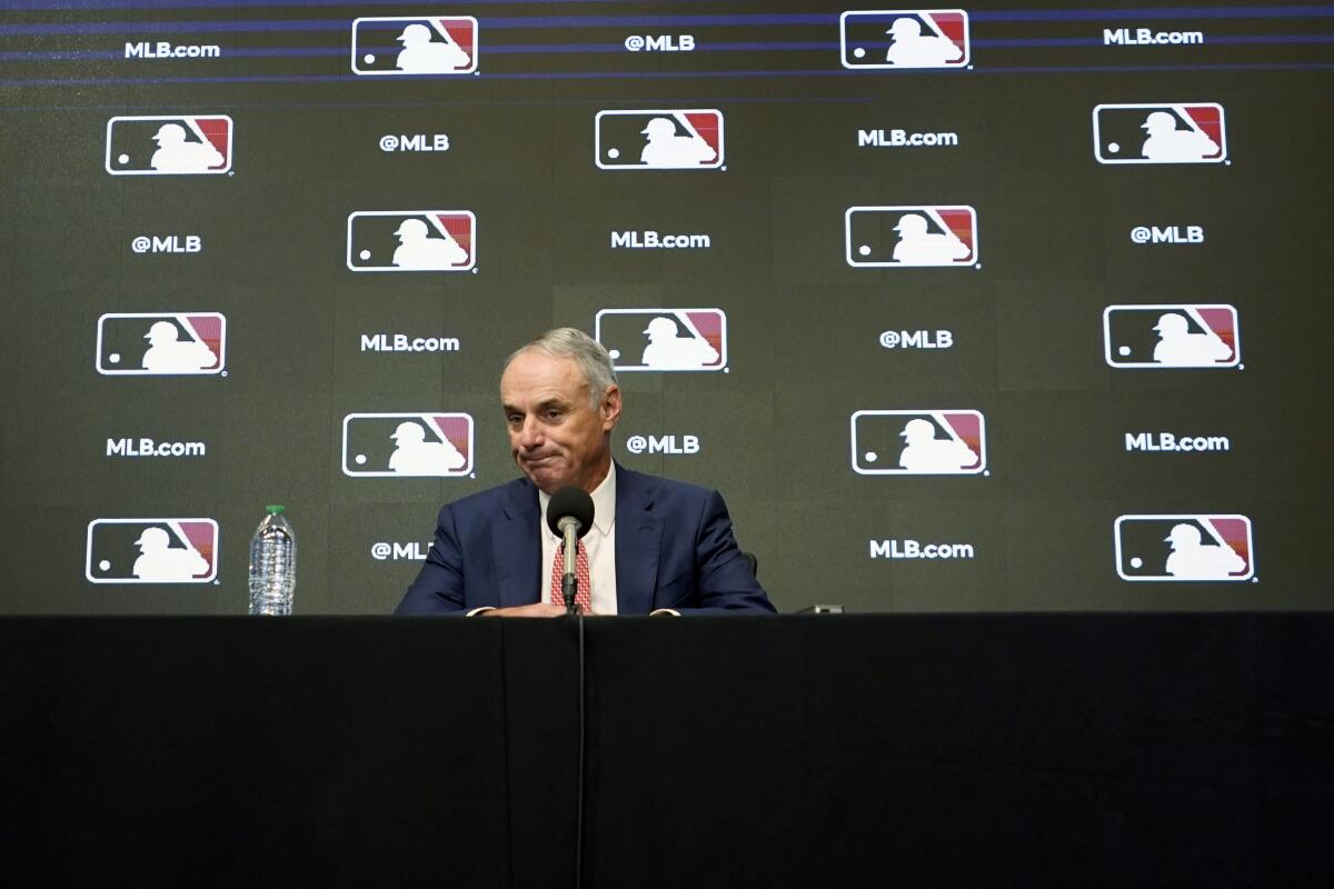 MLB Commissioner Rob Manfred pauses during a news conference Thursday in Arlington, Texas.