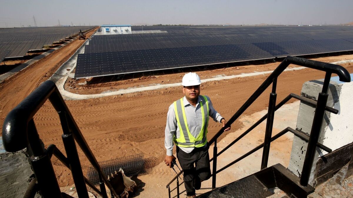 Plant manager Rajendra Gupta surveys the 100-megawatt solar field run by Fortum, a Finnish energy company, in Pavagada, India.