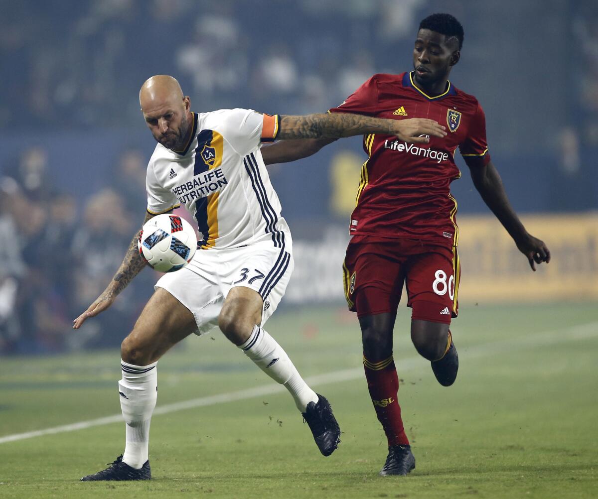 The Galaxy's Jelle Van Damme, left, protects the ball from Real Salt Lake's Olmes Garcia during a game on Oct. 26.