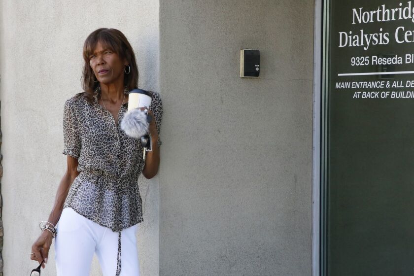 In this Sept. 27, 2018, photo Tangi Foster stands outside the Northridge Dialysis Center where she receives dialysis in Northridge, Calif. A ballot measure restricting profits at dialysis clinics has overtaken both the gas tax and rent control initiatives to become the most expensive California proposition this cycle. Foster, is working with the union to promote Proposition 8. She said she believes dialysis clinics prioritize profits over patients and pointed to the spending by the providers as evidence. (AP Photo Damian Dovarganes)