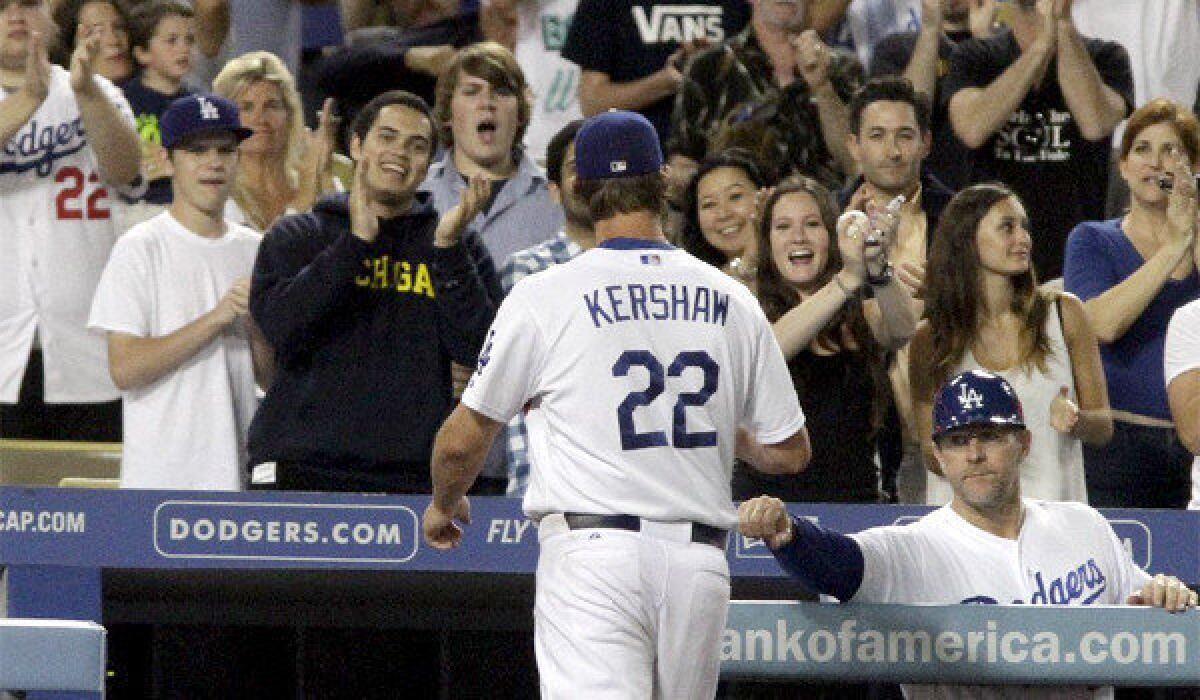 Clayton Kershaw walks off the field to a standing ovation after giving the Dodgers eight innings of work, giving up four hits, two earned runs while striking out seven Giants in L.A.'s 4-2 victory over San Francisco.