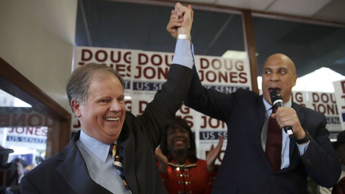 Democratic senatorial candidate Doug Jones, left, campaigns with Sen. Cory Booker (D-N.J.) in Birmingham.