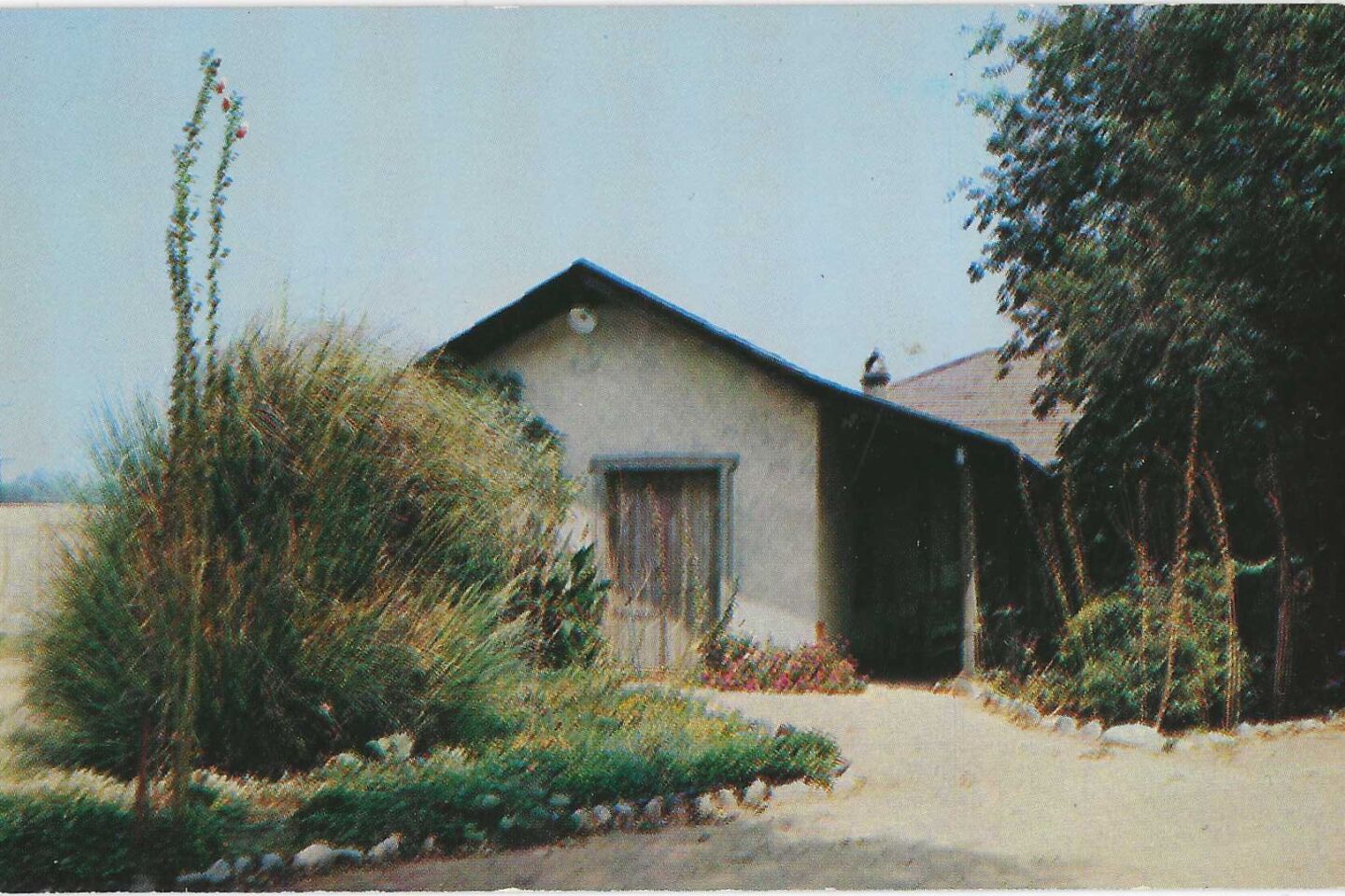The front of a postcard showing Palomares Adobe