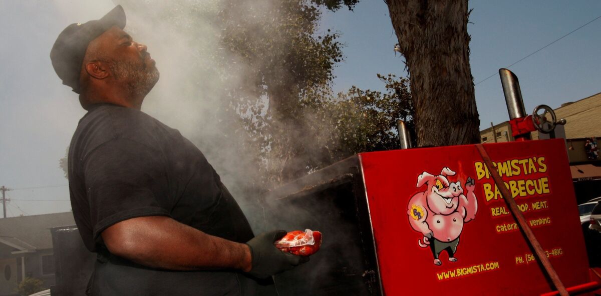 Neil Strawder smells the smoke at his farmers market stand.