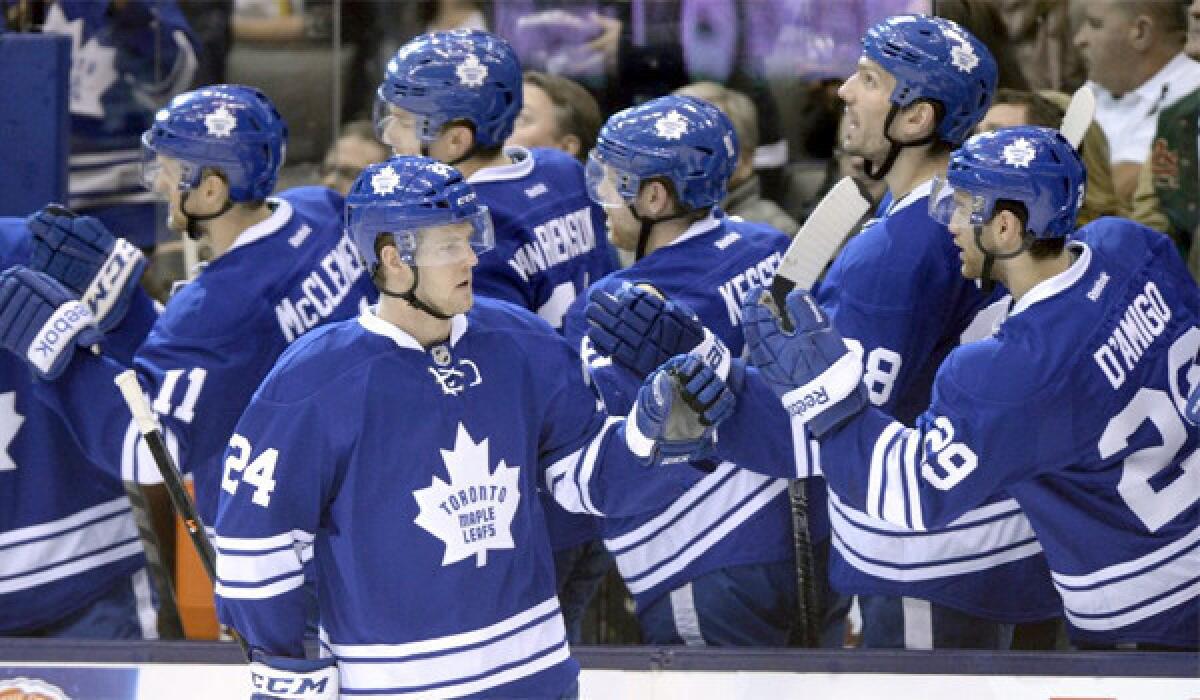 Peter Holland celebrates a goal with his Toronto Maple Leafs teammates during a game against the Boston Bruins on Sunday. The Bruins defeated the Maple Leafs, 5-2.