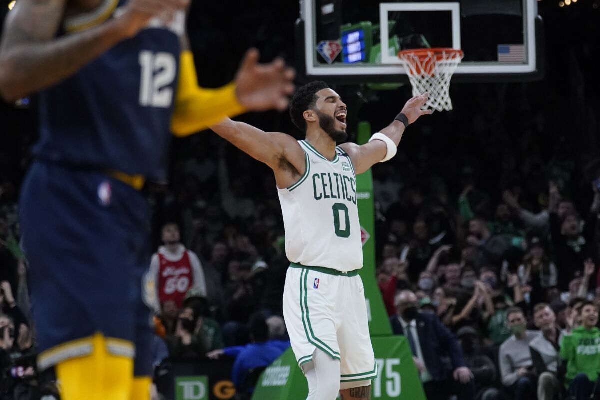 Boston Celtics forward Jayson Tatum (0) celebrates during the final minute of the second half of an NBA basketball game against the Memphis Grizzlies, Thursday, March 3, 2022 in Boston. Tatum scored 37 points as the Celtics defeated the Grizzlies 120-107. (AP Photo/Charles Krupa)