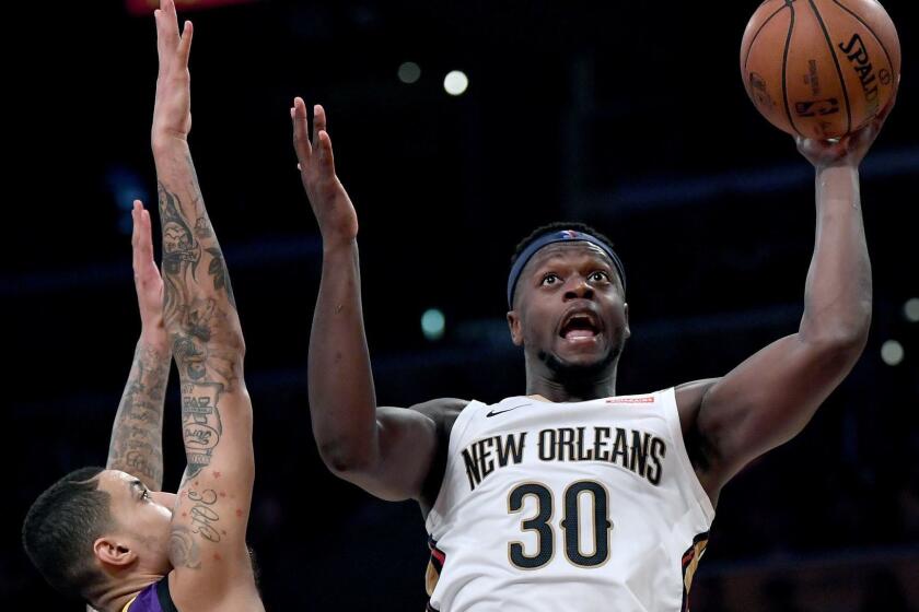 LOS ANGELES, CALIFORNIA - DECEMBER 21: Julius Randle #30 of the New Orleans Pelicans scores in front of Kyle Kuzma #0 of the Los Angeles Lakers during the first half at Staples Center on December 21, 2018 in Los Angeles, California. NOTE TO USER: User expressly acknowledges and agrees that, by downloading and or using this photograph, User is consenting to the terms and conditions of the Getty Images License Agreement. (Photo by Harry How/Getty Images) ** OUTS - ELSENT, FPG, CM - OUTS * NM, PH, VA if sourced by CT, LA or MoD **