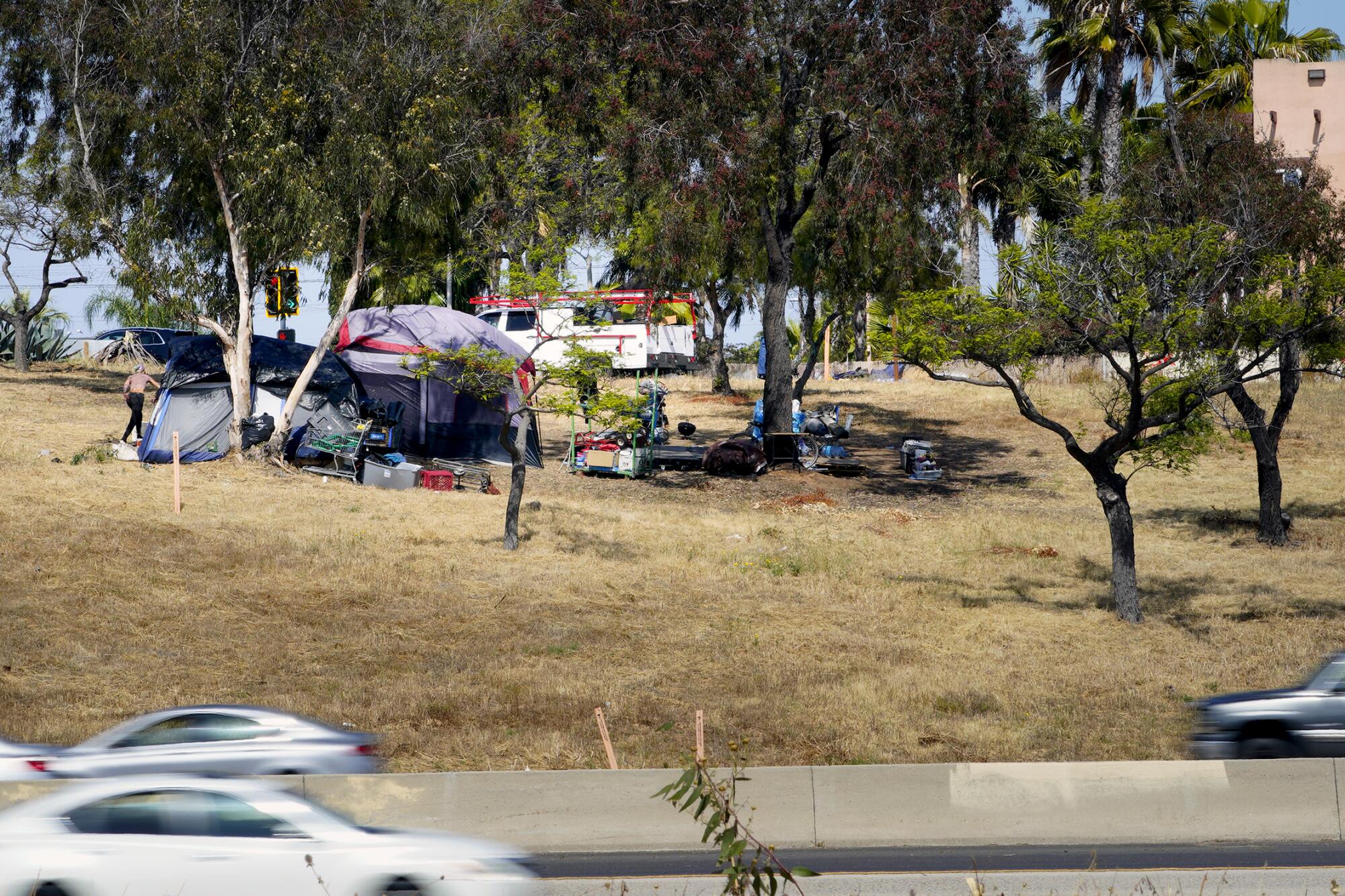 An encampment near the Palomar Street offramp on northbound Interstate 5 in Chula Vista.
