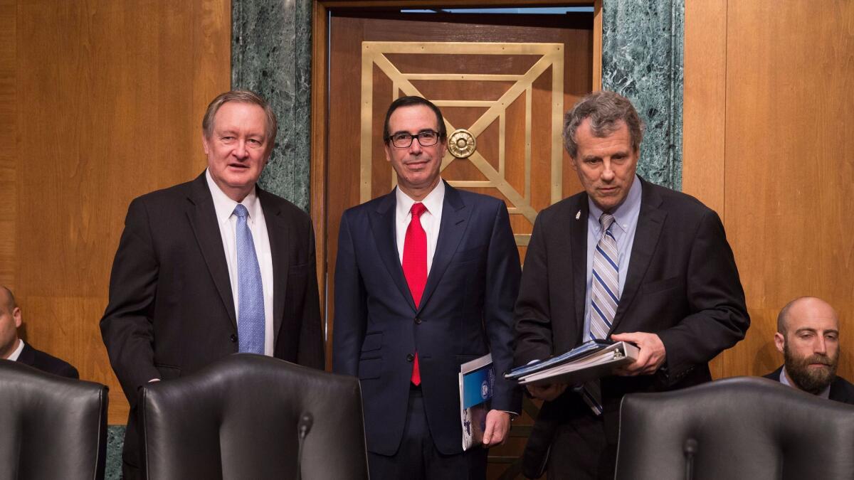 Senate Banking Committee Chairman Mike Crapo (R-Idaho), left, Treasury Secretary Steven T. Mnuchin and Sen. Sherrod Brown (D-Ohio) before a May hearing.
