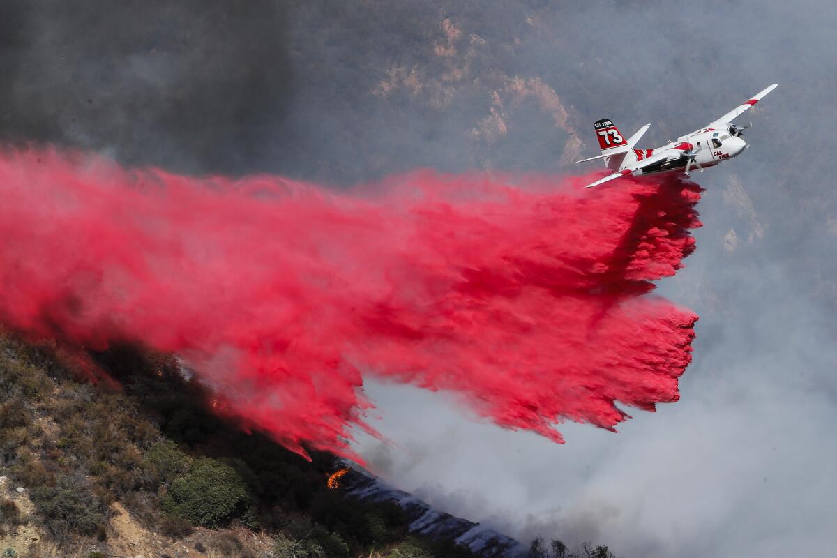L.A. County fire crews and air resources battle the East Fire in a remote area near East Fork and Glendora Mountain roads.