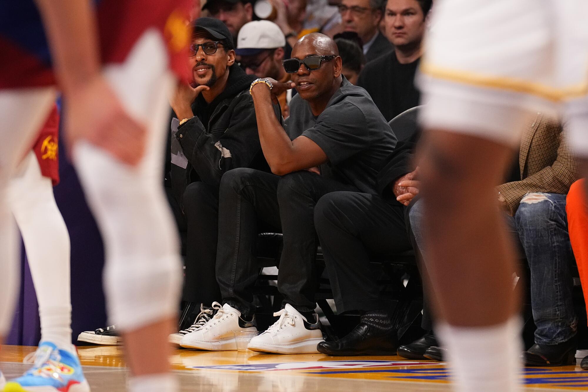 Dave Chappelle sits courtside