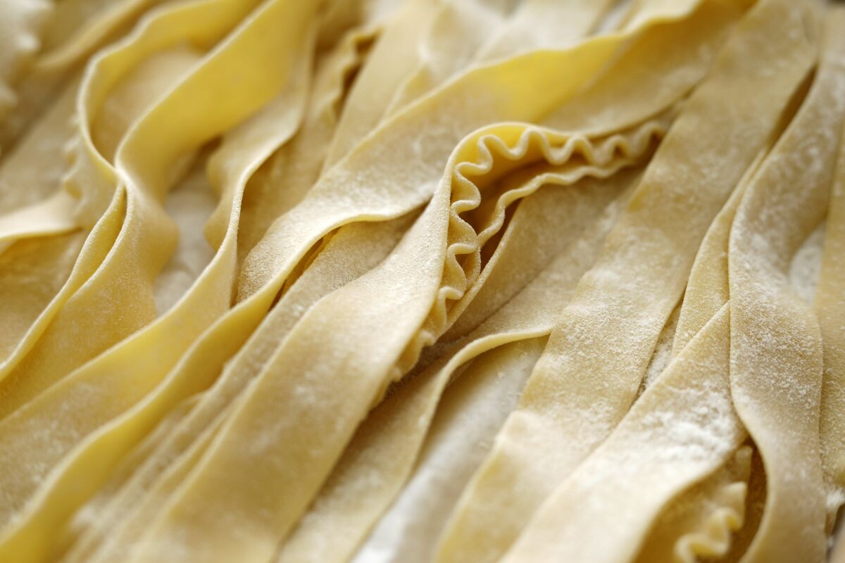 Strands of fresh fettuccine are displayed at Assenti's pasta-making shop in Little Italy.
