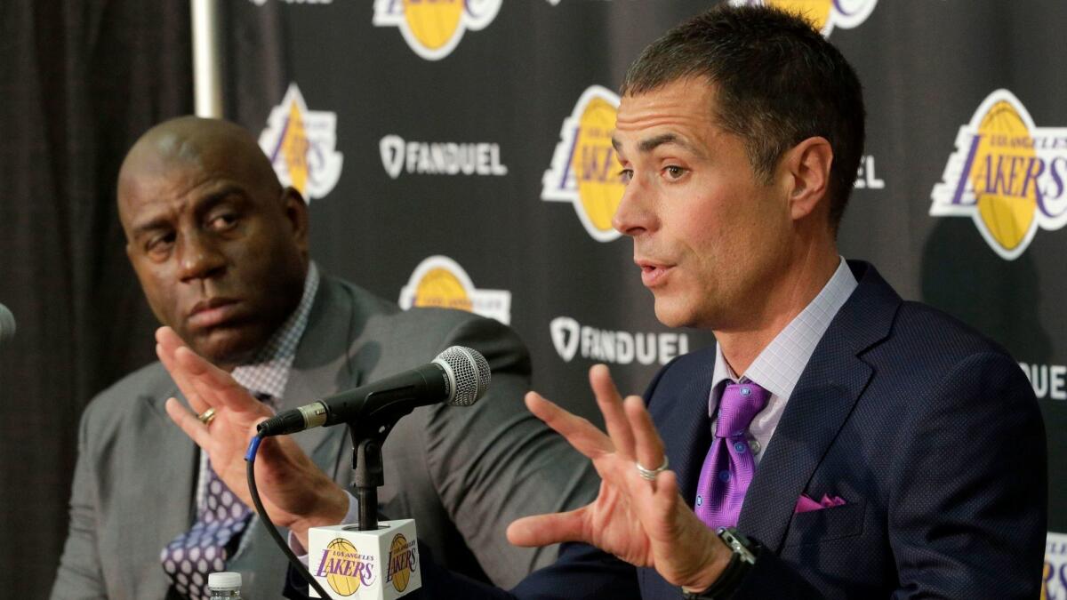 Magic Johnson, the Lakers' president of basketball operations, listens as new General Manager Rob Pelinka addresses the mdeia during an introductory news conference Friday in El Segundo.