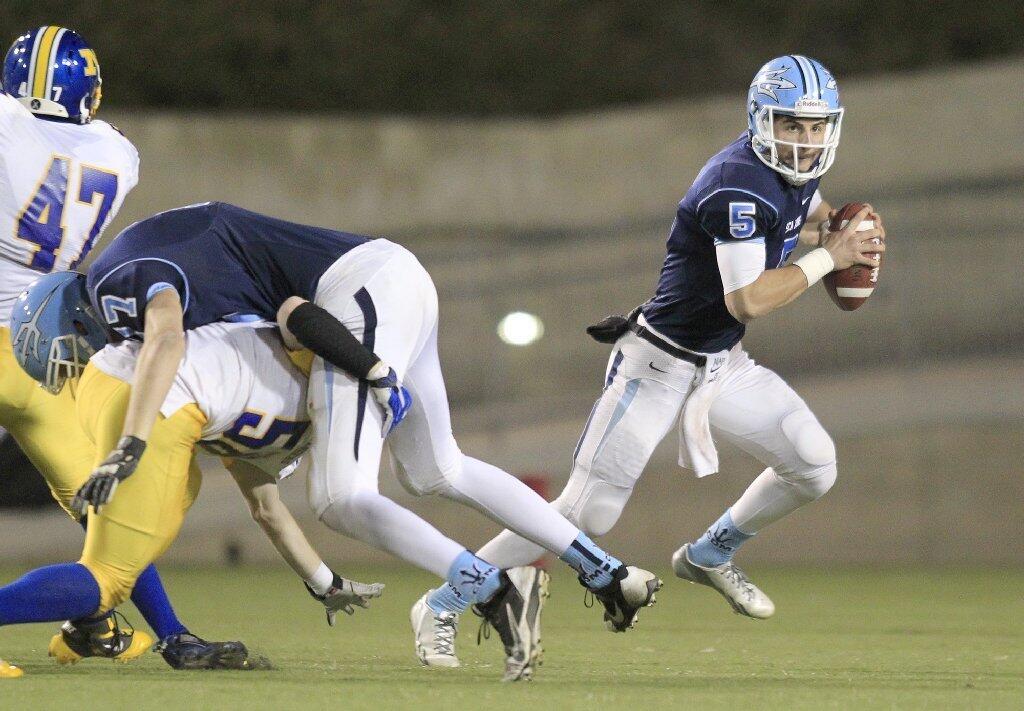 Corona del Mar High quarterback Luke Napolitano (5) scrambles out of the pocket during the first half against Nordhoff in the CIF State Southern California Regional Division III Bowl Game at LeBard Stadium in Costa Mesa on Saturday.