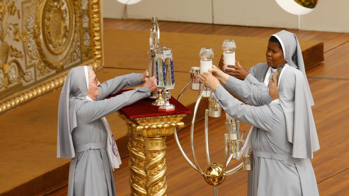 Nuns carry the relics of five new saints to the altar during a canonization ceremony in St. Peter's Square at the Vatican on April 26, 2009. The Vatican's saint-making office announced Saturday that it has updated its rules for relics.
