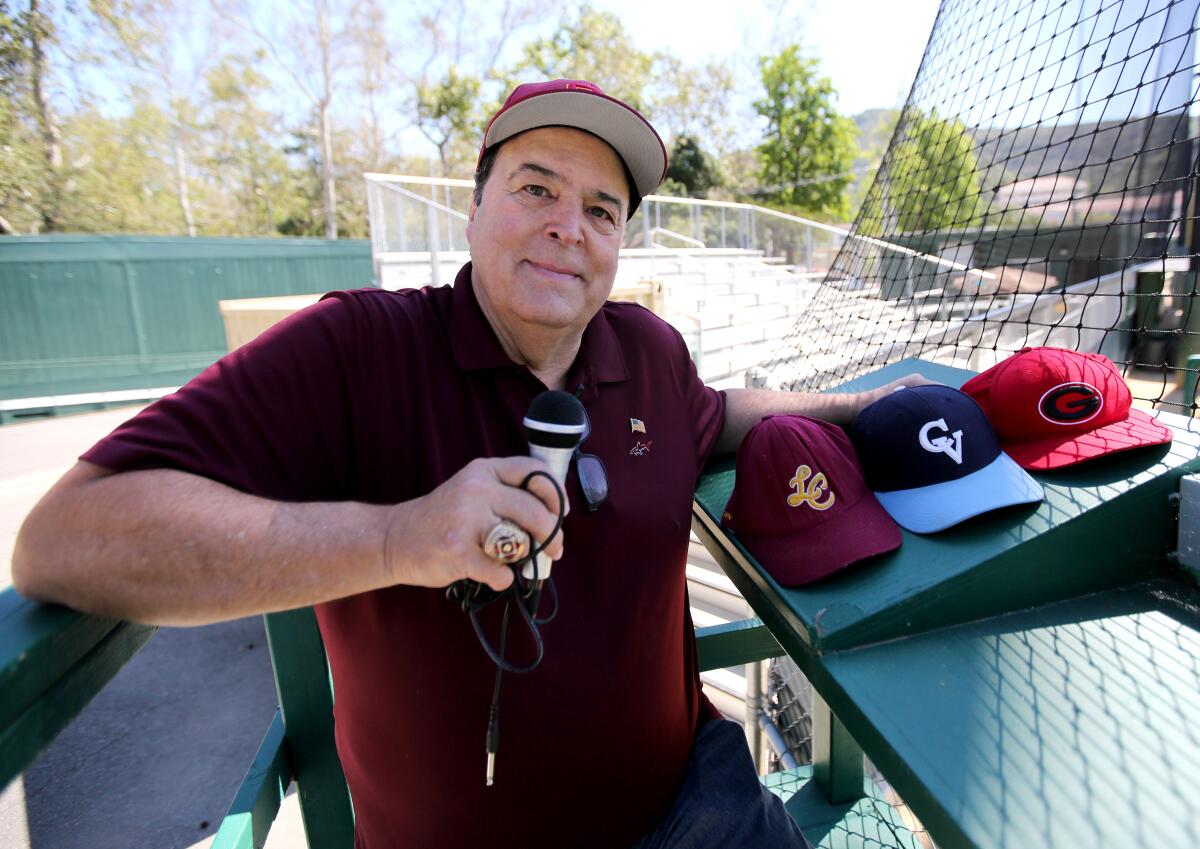 Area sports announcer Spiro Psaltis poses with a microphone at an empty Stengel Field in Glendale.
