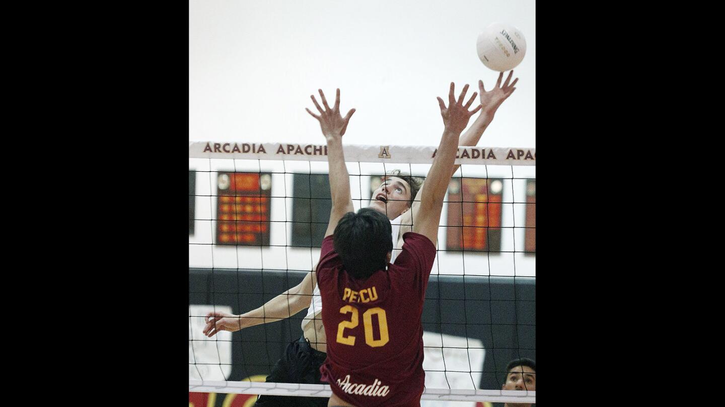 Burbank's Rory Rickey gets his fingers on the ball as Arcadia's Sebastian Petcu reaches for the block in the final game of the Pacific League boys' volleyball regular season on Tuesday, May 1, 2018. Arcadia won 3-0.