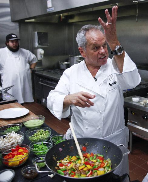 Wolfgang Puck addresses his assistant for the day, Los Angeles Times staff writer John Horn, while preparing dishes from the menu for the 2013 Academy Awards Governors Ball.