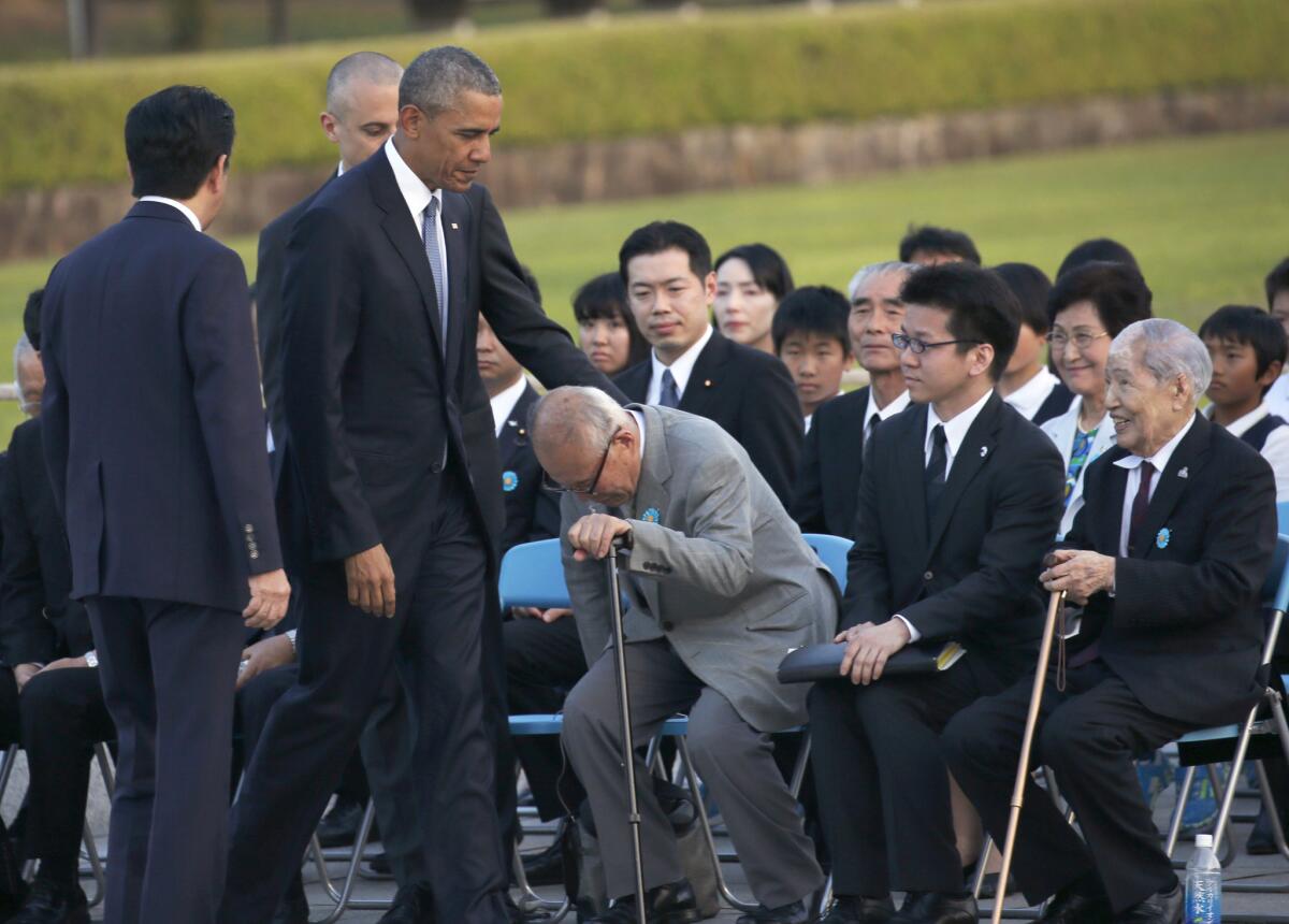 President Obama greets survivors of the atomic bombings at Hiroshima and Nagasaki, including Sunao Tsuboi, right, during Obama's visit Friday to the memorial at Hiroshima.