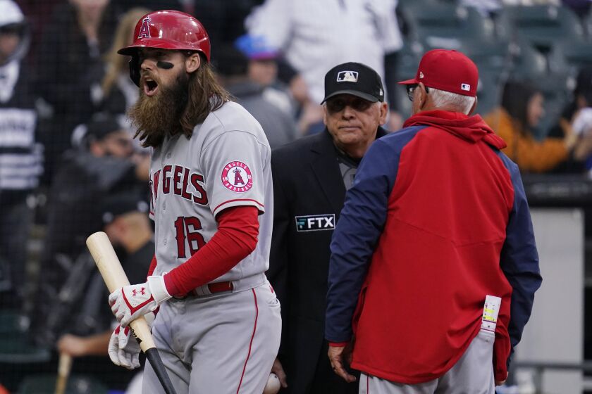 Los Angeles Angels' Brandon Marsh, left, reacts after being called out on strikes as manager Joe Maddon.