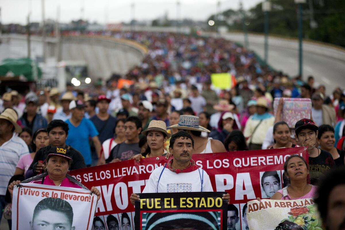 Relatives of the 43 missing Ayotzinapa teachers' college students lead a march on Sept. 26, 2015, to mark the anniversary of the students' disappearances in Mexico.