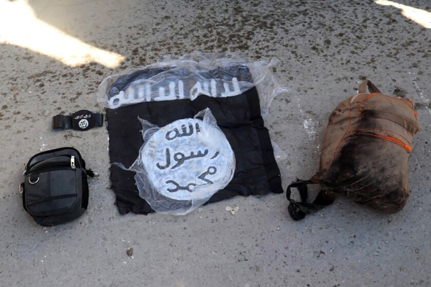 Islamic State flag and bags taken from ISIS fighters