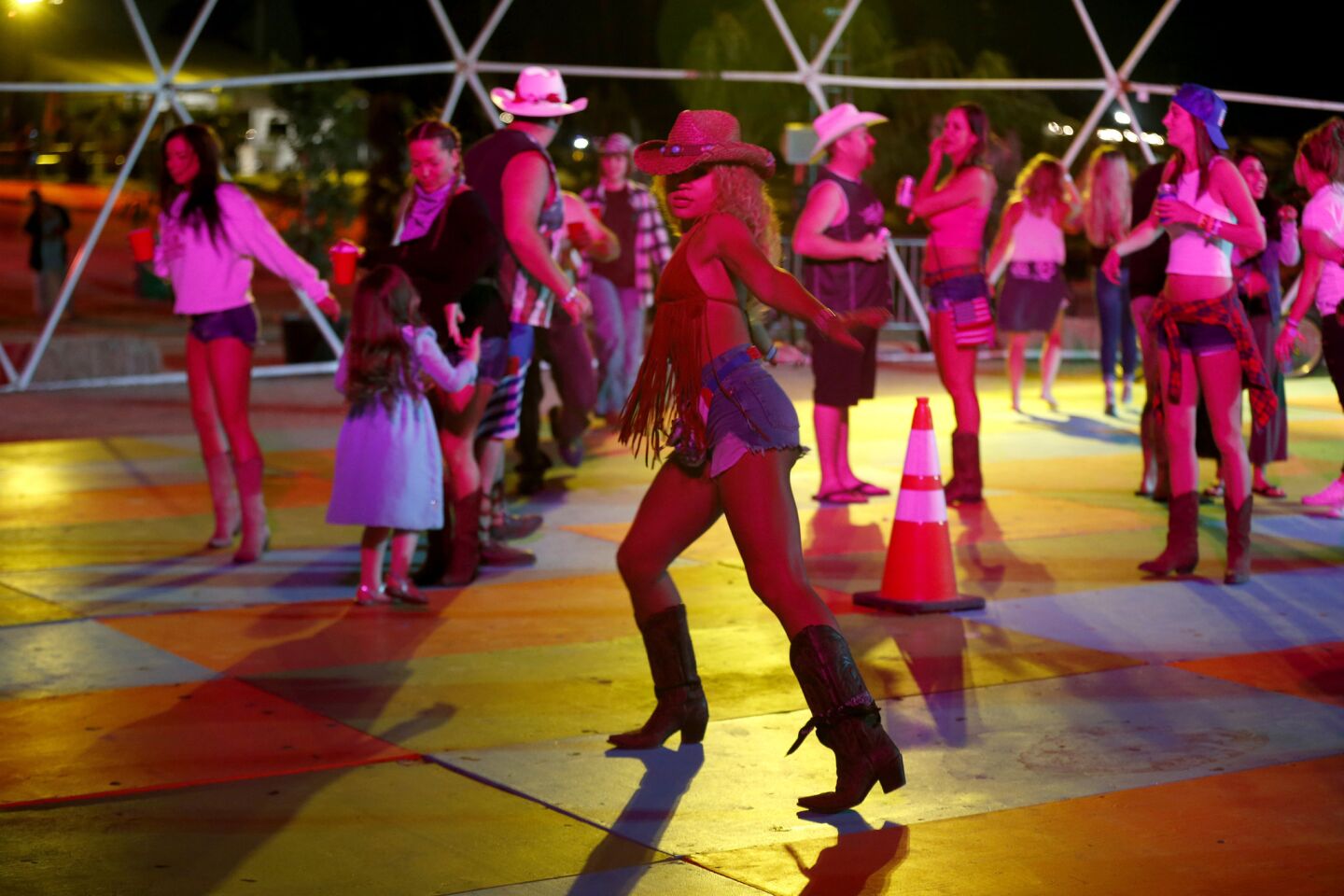 Jamella Perkins, center, joins fellow country music fans line dancing in the Dance Dome at Stagecoach Country Music Festival.