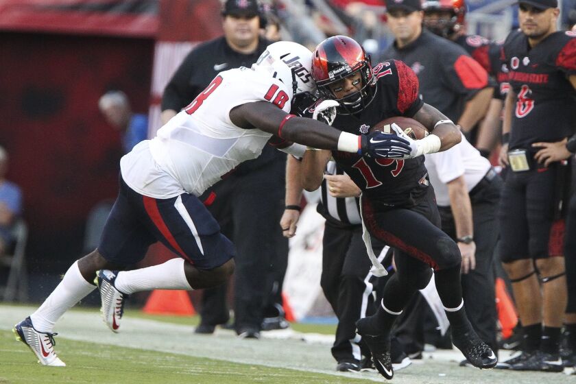 The Aztecs' D.J. Pumphrey is pushed out of bounds by South Alabama's Bull Barge during the second quarter at Qualcomm Stadium on Saturday. Photo by Hayne Palmour IV/San Diego Union-Tribune/Mandatory Credit: HAYNE PALMOUR IV/SAN DIEGO UNION-TRIBUNE/ZUMA PRESS San Diego Union-Tribune Photo by Hayne Palmour IV copyright 2015