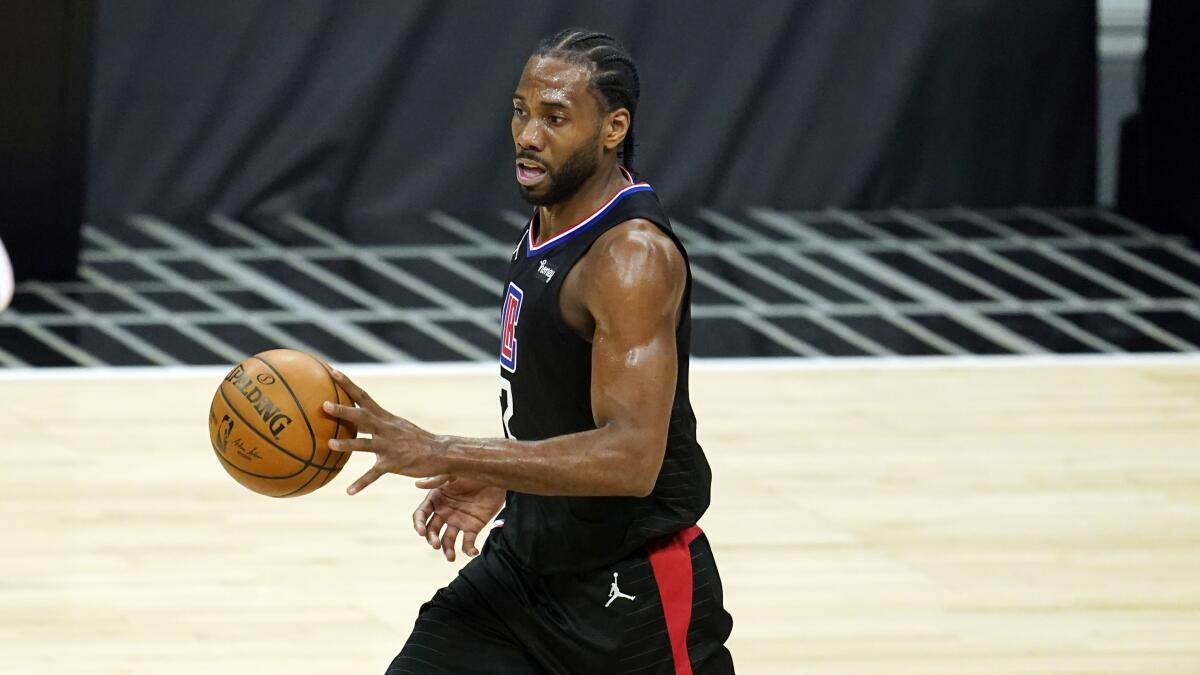 The Clippers' Kawhi Leonard handles the ball against the Phoenix Suns on April 8, 2021, in Los Angeles. 