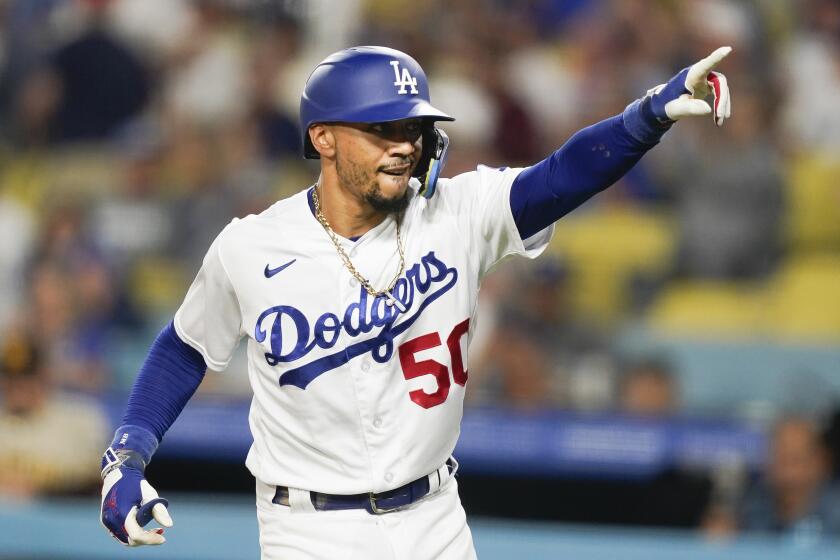 Dodgers' Mookie Betts celebrates after hitting a home run during the first inning against the San Diego Padres.