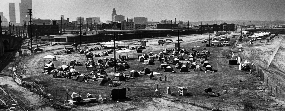June 26, 1987: A view of the "urban campground," located near the Los Angeles River at 4th Place and Santa Fe Avenue, looking northwest toward downtown Los Angeles.