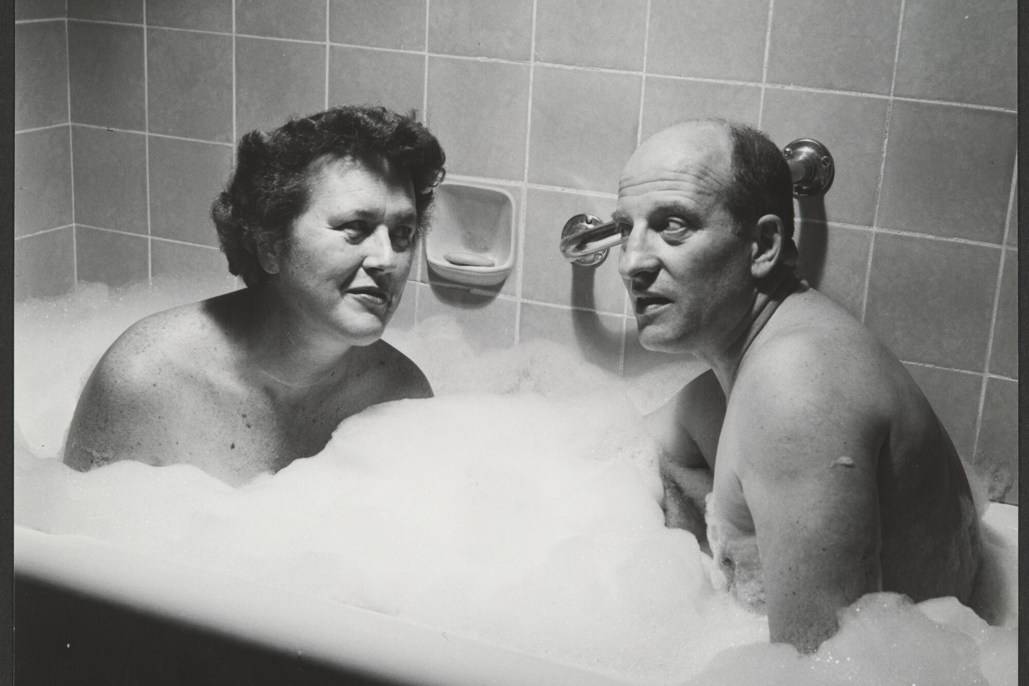 A woman, left, and a man in a bubble bath 