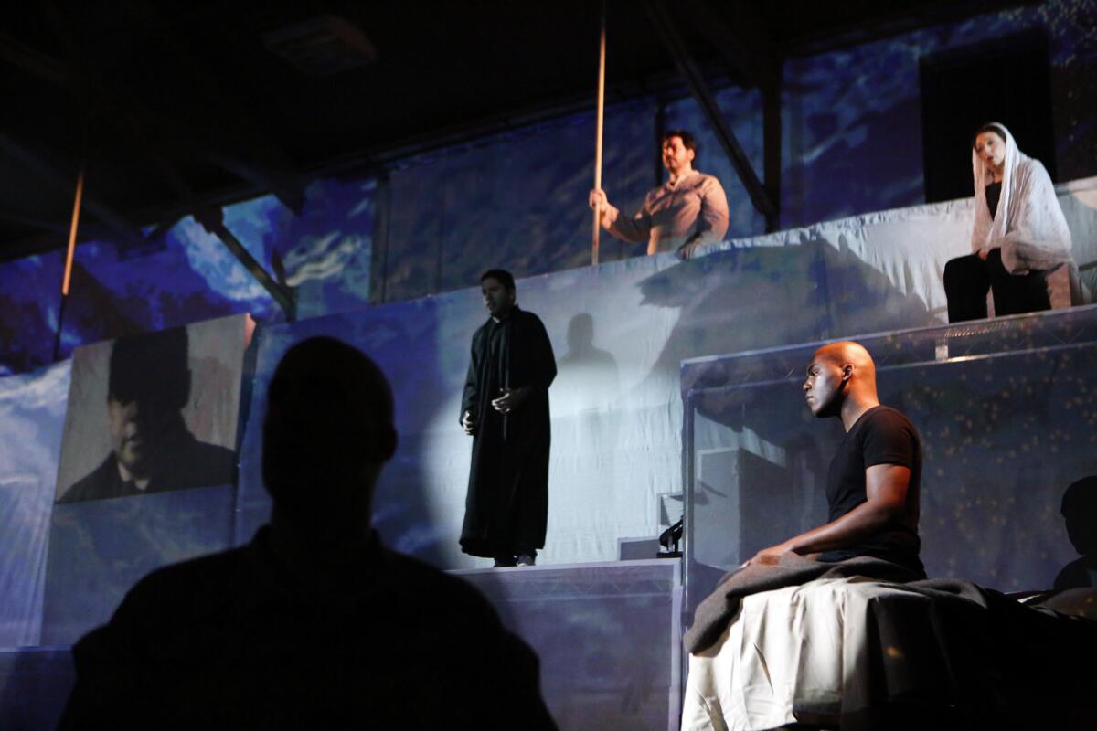 Clockwise from top, Zeffin Quinn Hollis, Ani Maldjian, LaMarcus Miller, Jason Switzer and Jonathan Lacayo perform a scene from the opera "Fallujah" at the Army National Guard in Long Beach.
