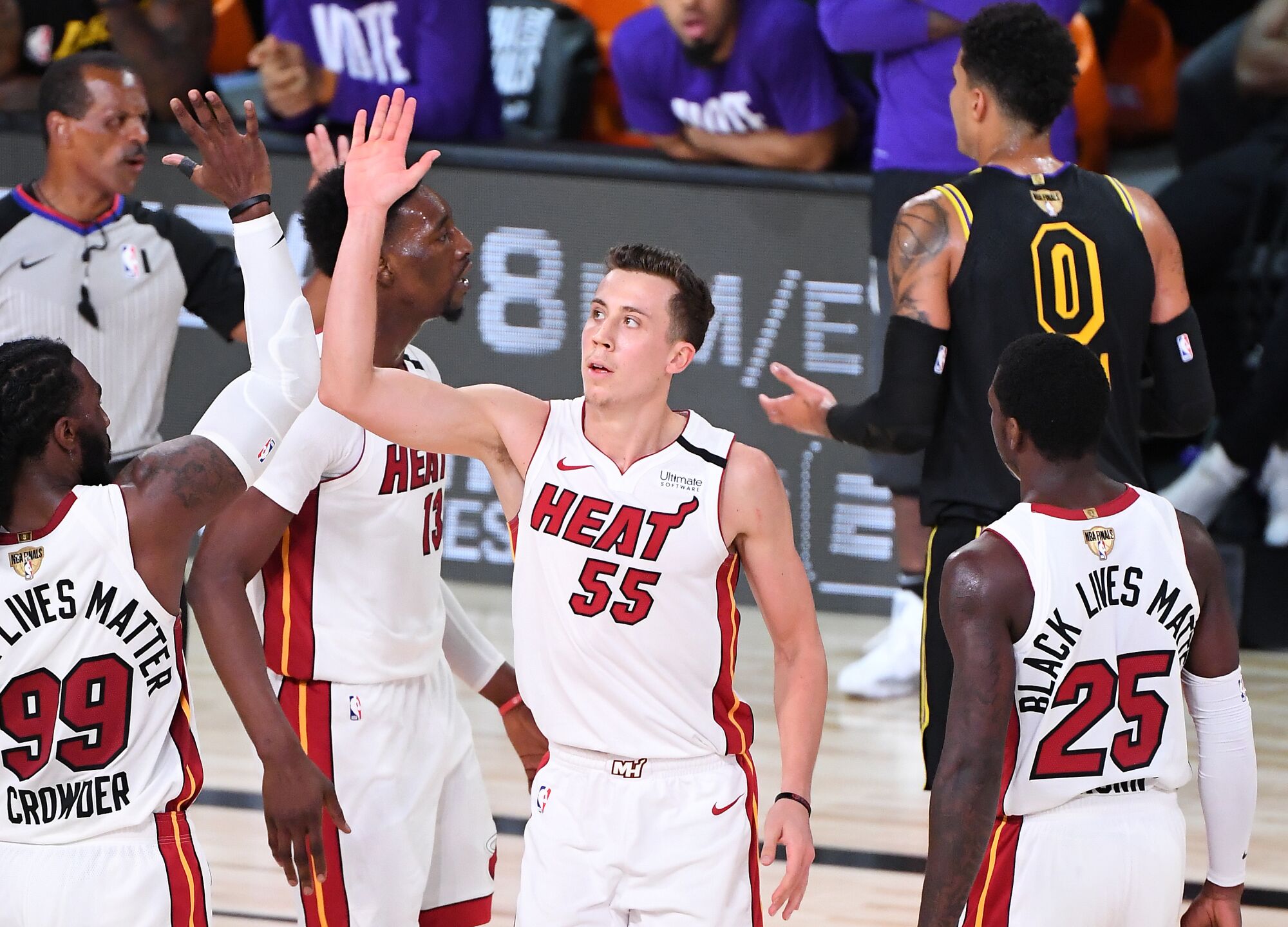 Miami Heat guard Duncan Robinson, center, celebrates with teammate Jae Crowder after making a three-pointer.