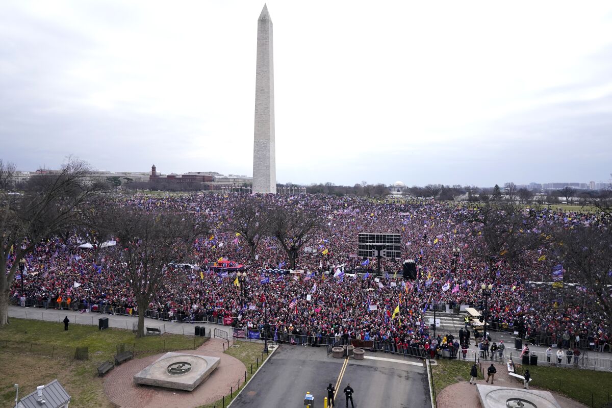 FILE - With the Washington Monument in the background, people attend a rally in support of President Donald Trump on Jan. 6, 2021, in Washington. Intelligence reports compiled by the U.S. Capitol Police in the days before last year's insurrection envisioned only an improbable or remote risk of violence, even as other assessments warned that crowds of potentially tens of thousands of pro-Trump demonstrators could converge in Washington to create a dangerous situation. (AP Photo/Jacquelyn Martin, File)
