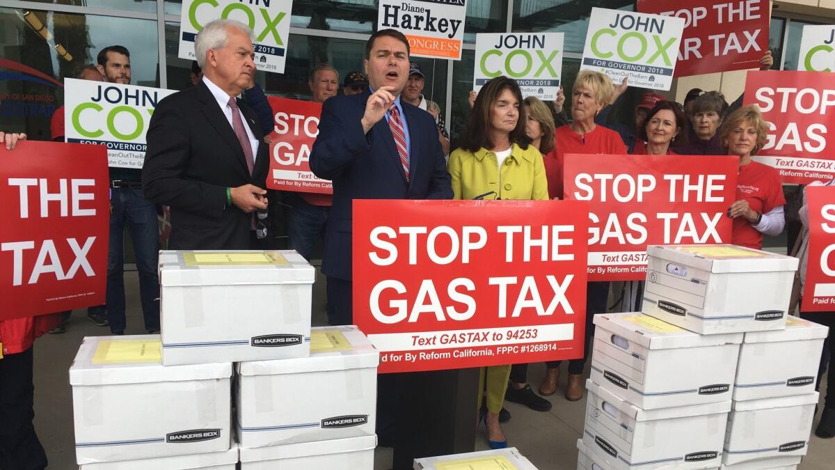 Republican gubernatorial candidate John Cox, left, and organizer Carl DeMaio, center, stand April 30 outside the San Diego Registrar of Voters building.