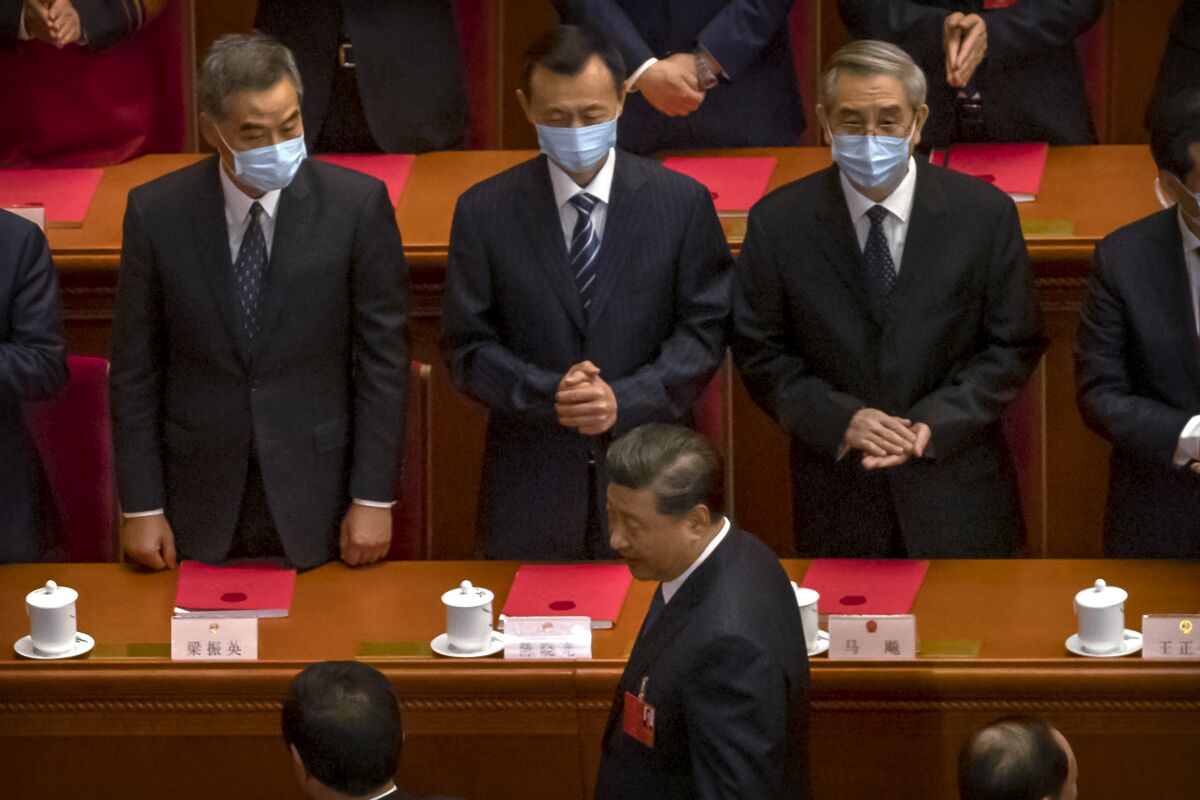 Former Hong Kong leader C.Y. Leung, left, and other delegates greet Chinese President Xi Jinping, foreground, on May 28, 2020.
