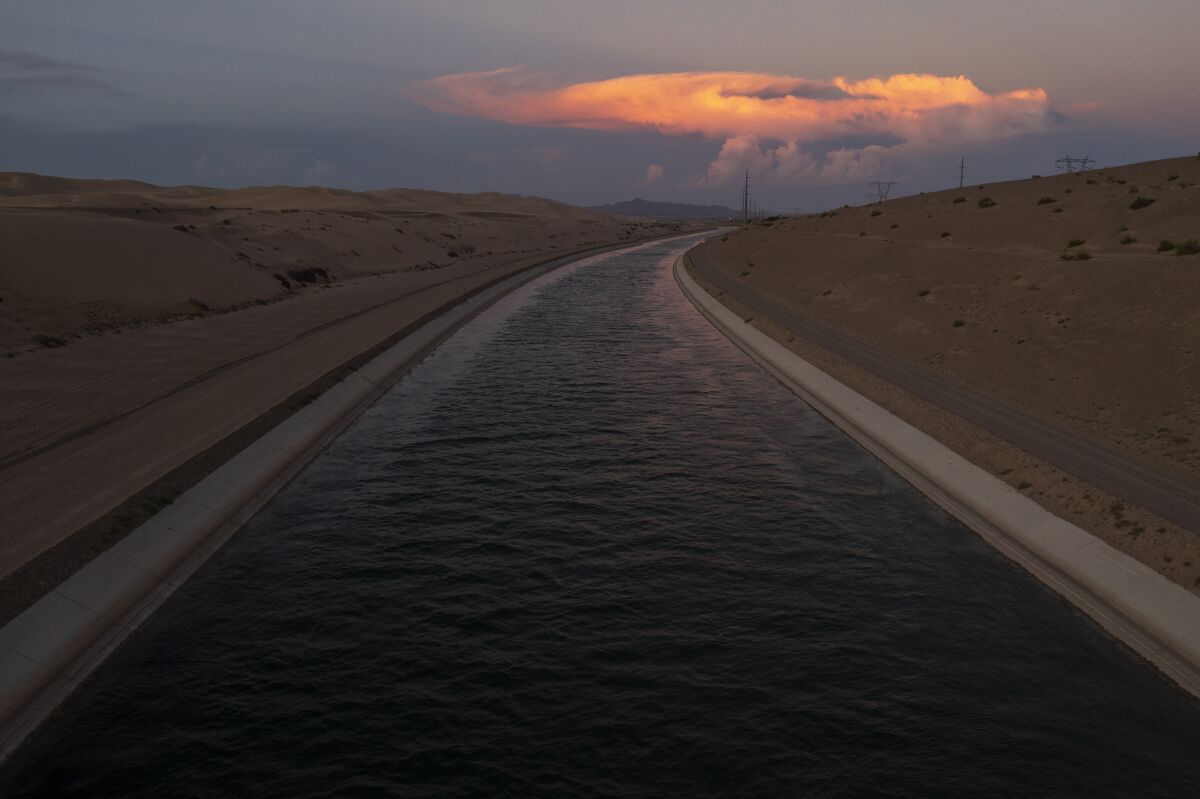 Water in a concrete-lined canal running through the desert