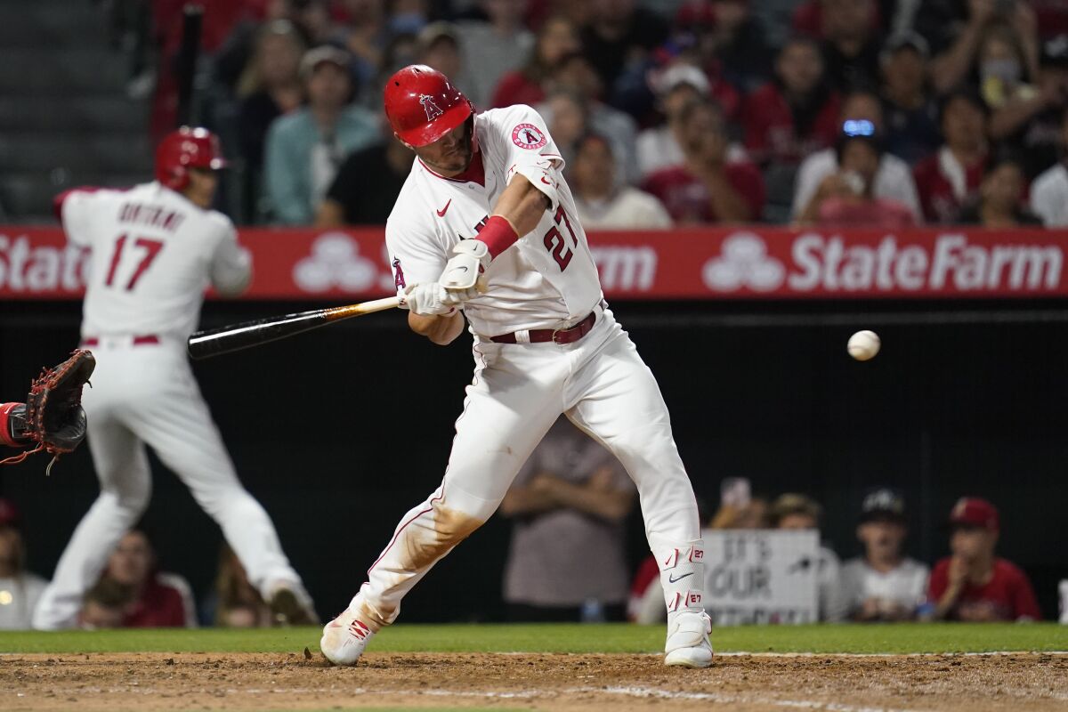 Los Angeles Angels' Mike Trout (27) doubles to center field during the fifth inning of a baseball game against the Washington Nationals in Anaheim, Calif., Friday, May 6, 2022. Tyler Wade and David Fletcher scored. (AP Photo/Ashley Landis)