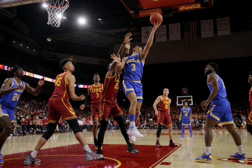 LOS ANGELES, CA - MARCH 7, 2020: UCLA Bruins guard Jules Bernard (3) drives to the basket against USC Trojans forward Onyeka Okongwu (21) in the first half at Galen Center on March 7, 2020 in Los Angeles, California. (Gina Ferazzi/Los AngelesTimes)