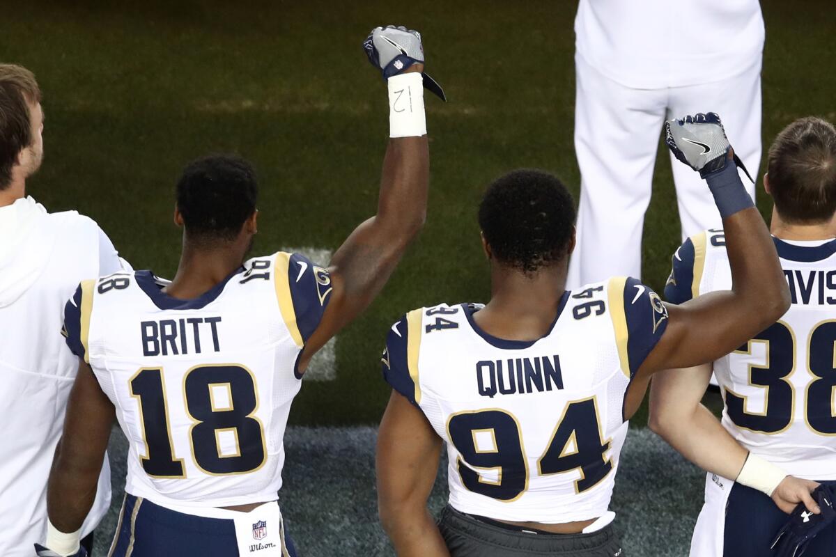 Rams receiver Kenny Britt and defensive lineman Robert Quinn raise their fists in protest before playing the San Francisco 49ers.