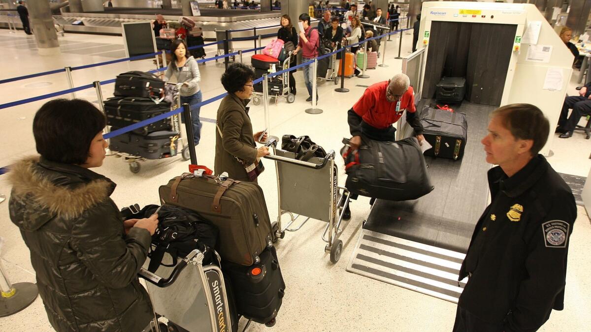 International travelers have their baggage examined by U.S. Customs and Border Protection agents upon arrival to Los Angeles International Airport in 2009.