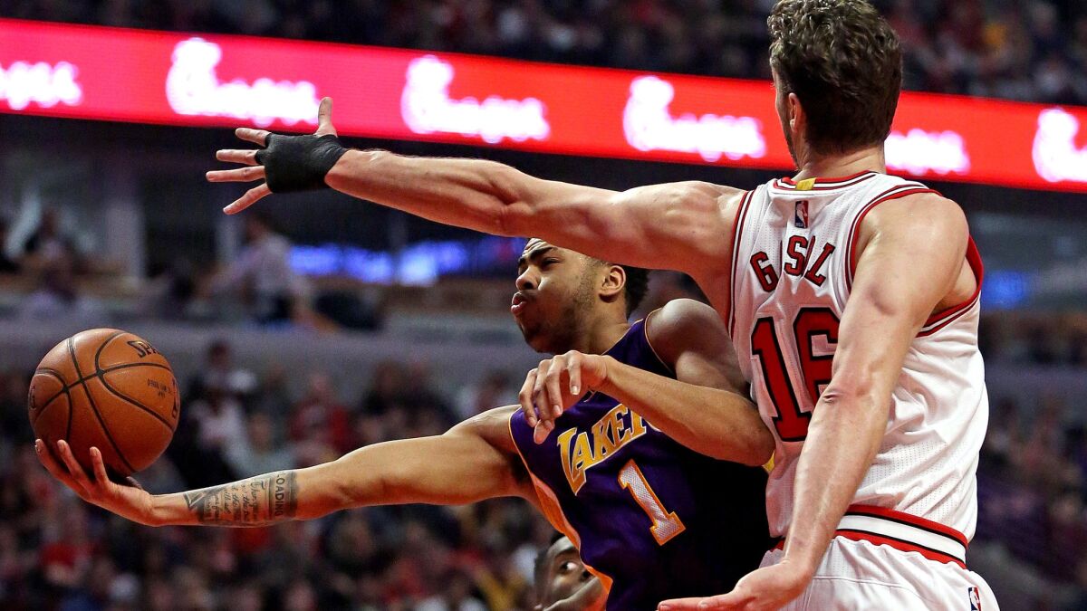 Lakers guard D'Angelo Russell has his layup challenged by Bulls center Pau Gasol during their game Sunday in Chicago.