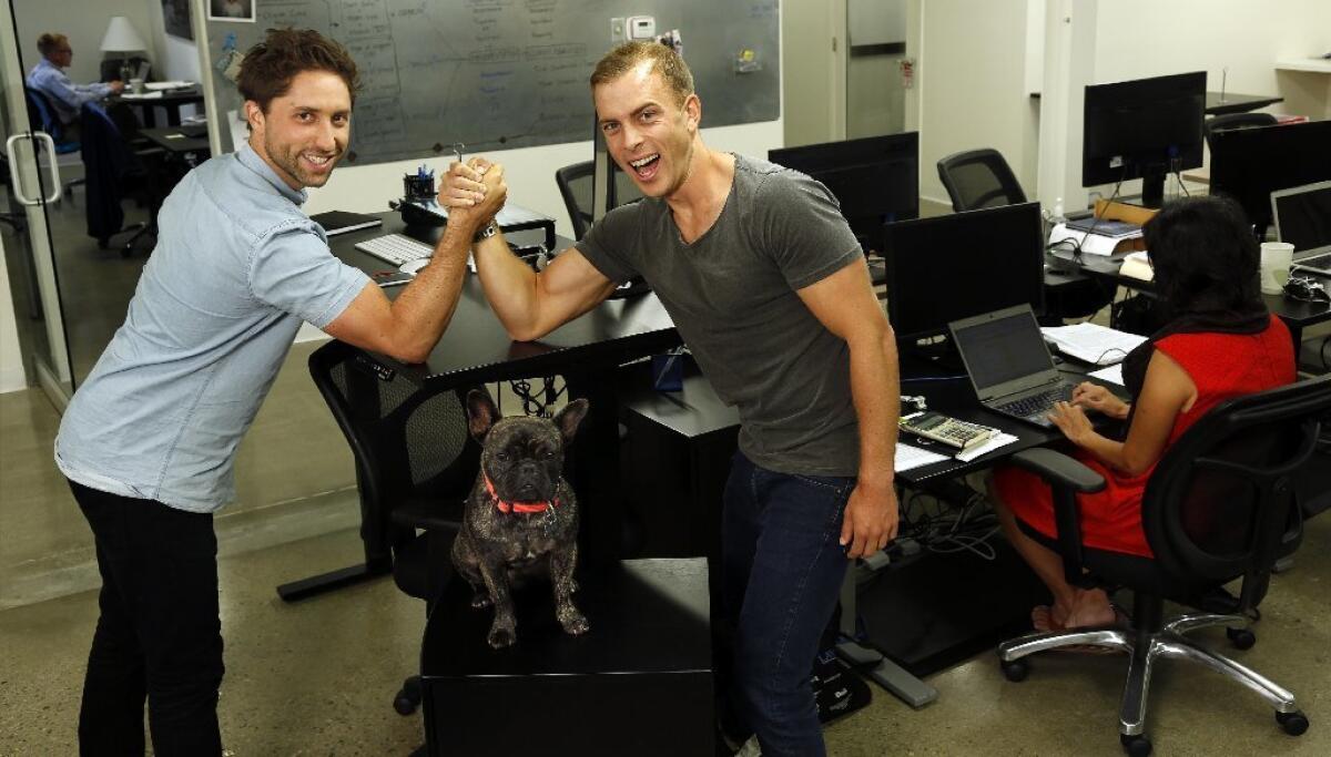 Jaspar Weir, left, and Bryce Maddock, co-founders of TaskUs, with Maddock's French bulldog, Mr. Carter.