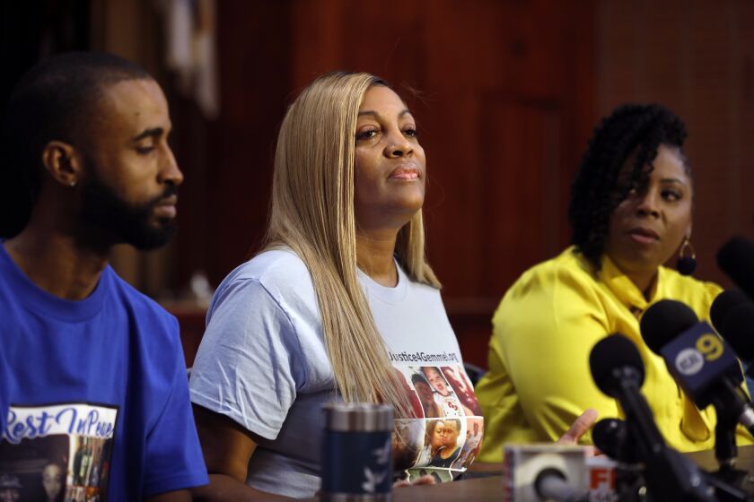 WEST HOLLYWOOD, LOS ANGELES--SEPT. 25, 2019--LaTisha Nixon, mother of Gemmel Moore, center, during a press conference at West Hollywood Park, to discuss the arrest of Ed Buck and other related matters. At left is Cory McLean, one of Gemmel's best friends and at right is Jasmyne Cannick, spokesperson for the Gemmel Moore family. Ed Buck administered a lethal dose of drugs to her son. Nixon's attorney Hussain Turk speaks about the case. (Carolyn Cole/Los Angeles Times)